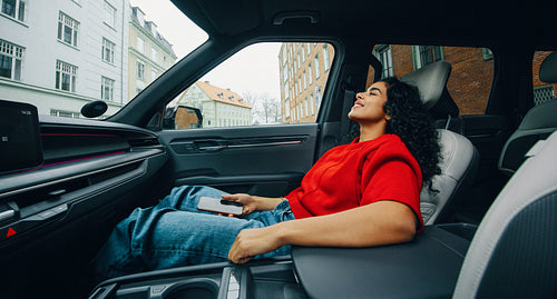 Urban travel gives the woman a quiet moment as a passenger in the car