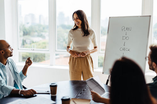 Business woman discussing with her team in a boardroom meeting