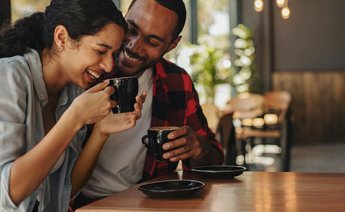 Affectionate couple having coffee on a date