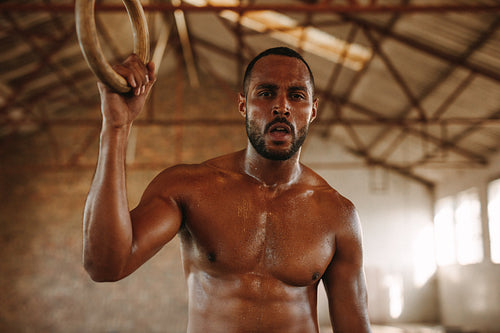 Muscular man taking break after workout