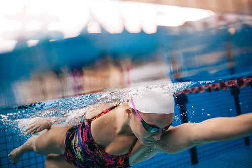 Underwater shot of woman swimming in pool