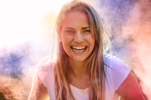Close up portrait of a happy woman playing holi