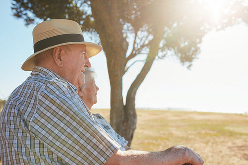 Elderly couple relaxing outdoors on a summer day