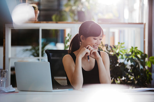 Woman sitting at desk looking at documents