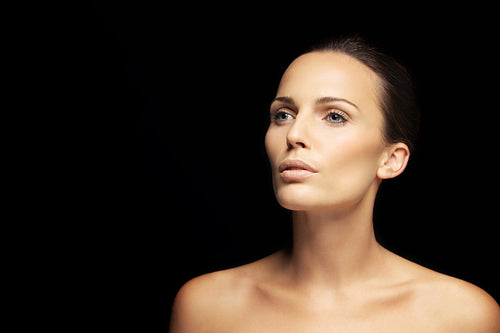 Pretty young brunette looking away at copyspace