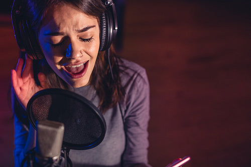 Singer singing a song in the recording studio