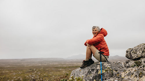 Cheerful senior woman enjoying her hiking trip