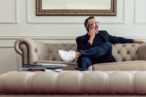 Smiling business man having a conversation on phone