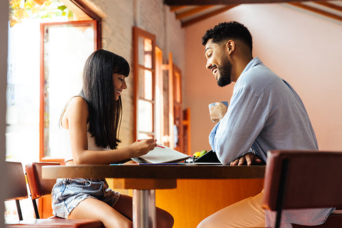 Father and daughter working on homework together at home