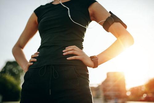 Fit young woman standing with her hands on hips
