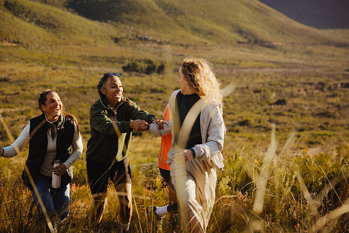 Friends hiking together in sunny nature