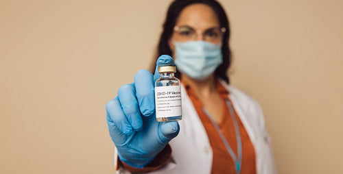 Doctor holding covid-19 vaccine