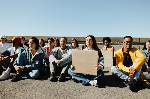 Group of diverse young adults participating in a public demonstration outdoors
