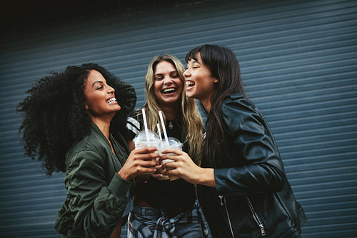 Smiling young women with ice coffee