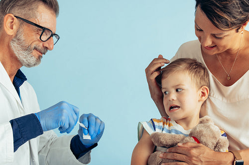 Scared boy having vaccine injection