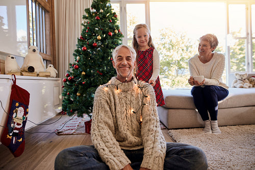 Happy family arranging the christmas lights and having fun