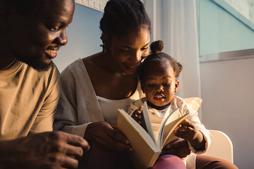Family reading together at home