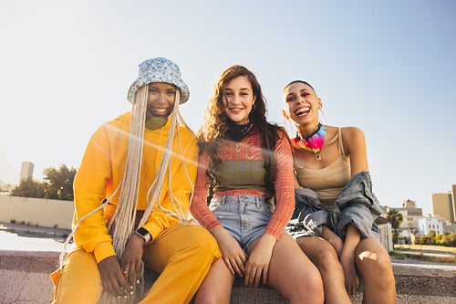 Cheerful female friends having a good time outdoors