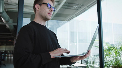 Software engineer talking to his team in an office