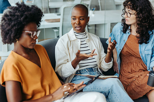 Group of business women brainstorming and discussing ideas in a modern office