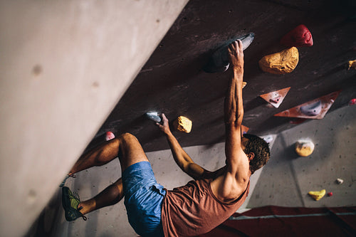 Man climbing indoor boulder wall