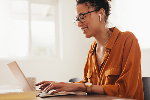Woman blogger using laptop at home