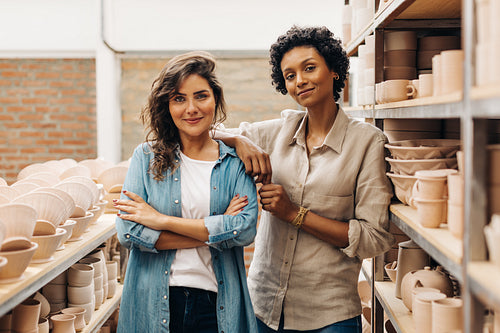 Creative businesswomen looking at the camera in their ceramic store
