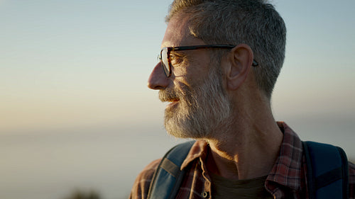 Male hiker looking at sunset view