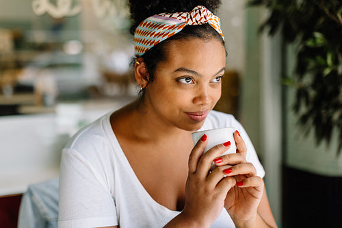 Young woman enjoying coffee at a cafe