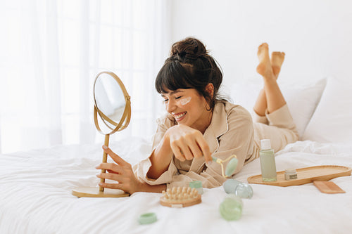 Woman enjoying skin care activity at home