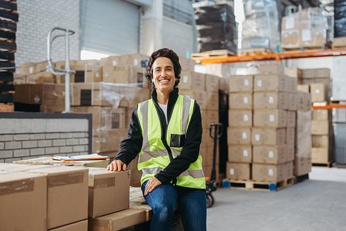 Cheerful warehouse supervisor smiling at the camera