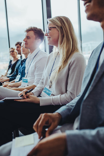 Group of businesspeople sitting at seminar
