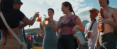 Group of friends cheering beers at a festival