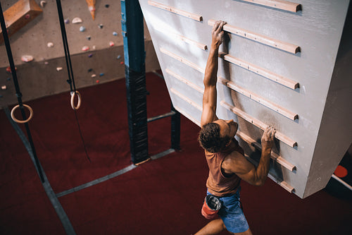 Man training on a campus board