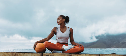 Athlete woman relaxing with basketball outdoors