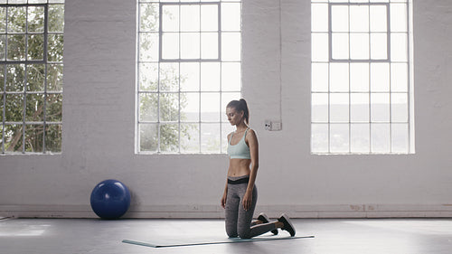Woman doing push up holds at fitness studio