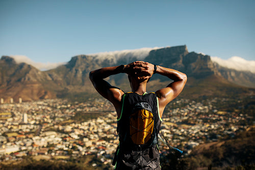 Athletic man taking a break after trail running
