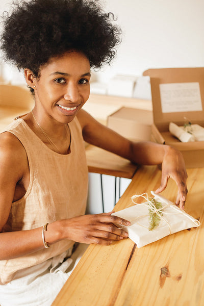 Business owner with packed jewelry parcel for delivery