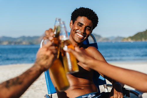 Man enjoying good times with friends on a summer day at the beach