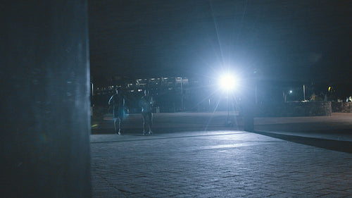 Couple jogging outdoors at night in city