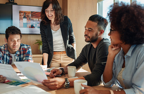 Team brainstorming in meeting room with color palette