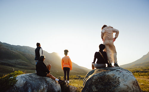 Group of friends hiking at sunset