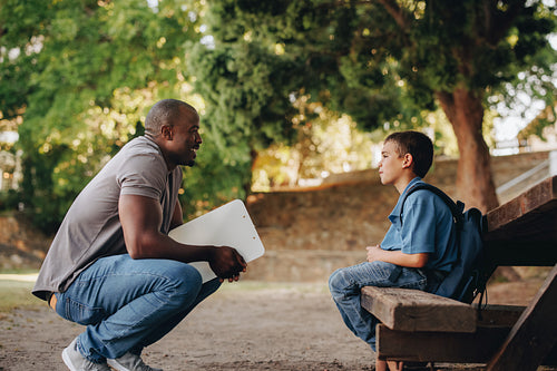 Mentor talking to a young school kid outside class