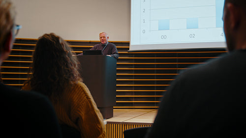 Business conference: Professionals listening to a speaker in a seminar