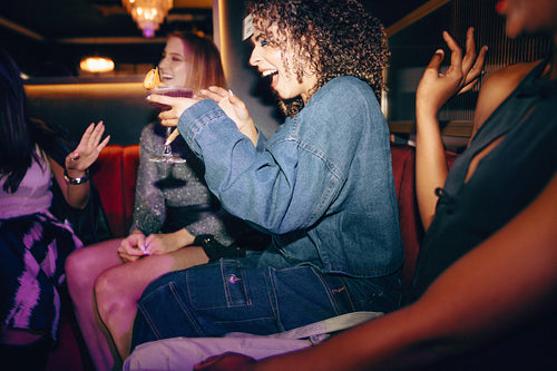 Group of friends enjoying drinks together at a stylish evening gathering