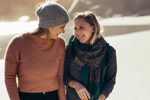 Best friends strolling on the beach