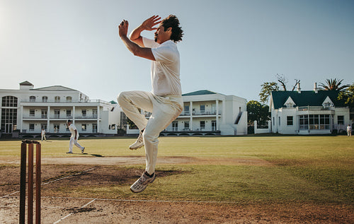 Male bowler in action on a sunny field