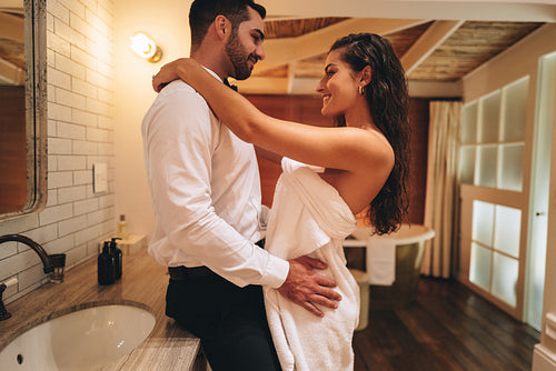 Lovers dressing up in a hotel room