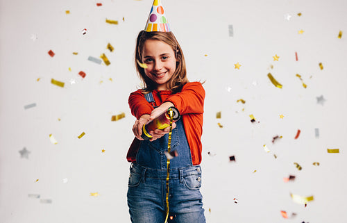 Girl bursting a party popper