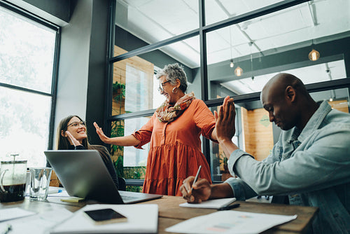 Happy businesspeople celebrating their success in an office